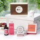 Dublin Herbalist Pamper Treat Box. A collection of beauty products displayed on a table, including a box of chocolates, various skincare items, and a scented candle. The items feature elegant packaging, with brands like "Butlers" and "Dublin Herbalists." The background shows greenery, adding a fresh ambiance to the scene. Dublin Herbalist Pamper Treat Box. A collection of beauty products displayed on a table, including a box of chocolates, various skincare items, and a scented candle. The items feature elegant packaging, with brands like "Butlers" and "Dublin Herbalists." The background shows greenery, adding a fresh ambiance to the scene.